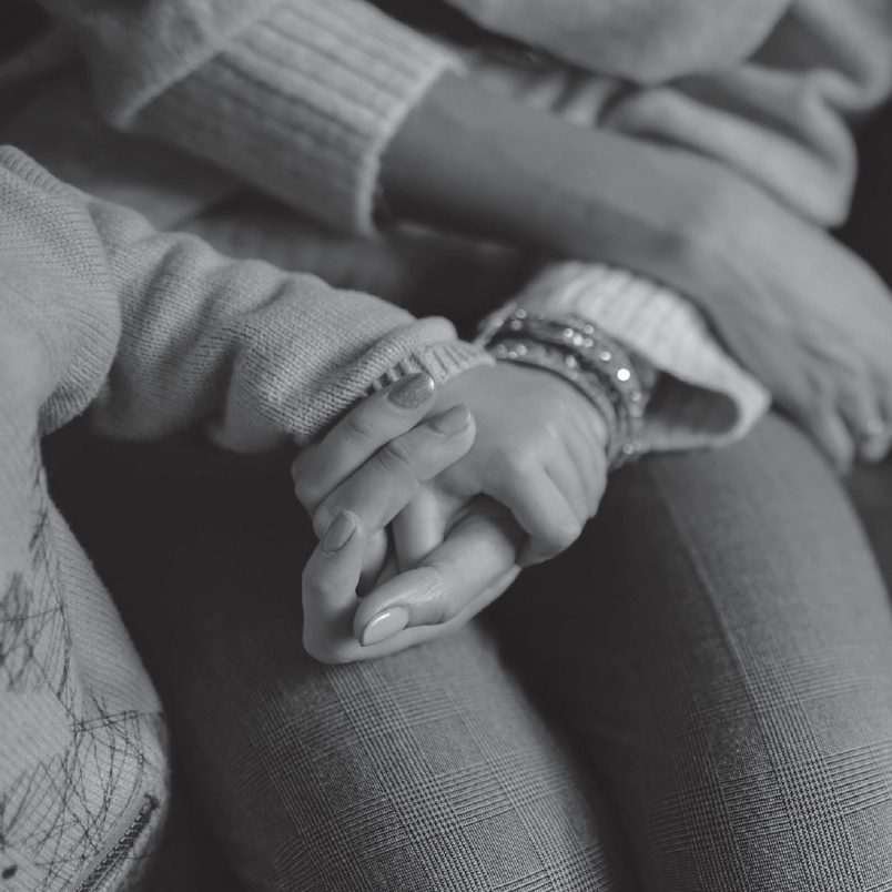 Mother holding hands with her child